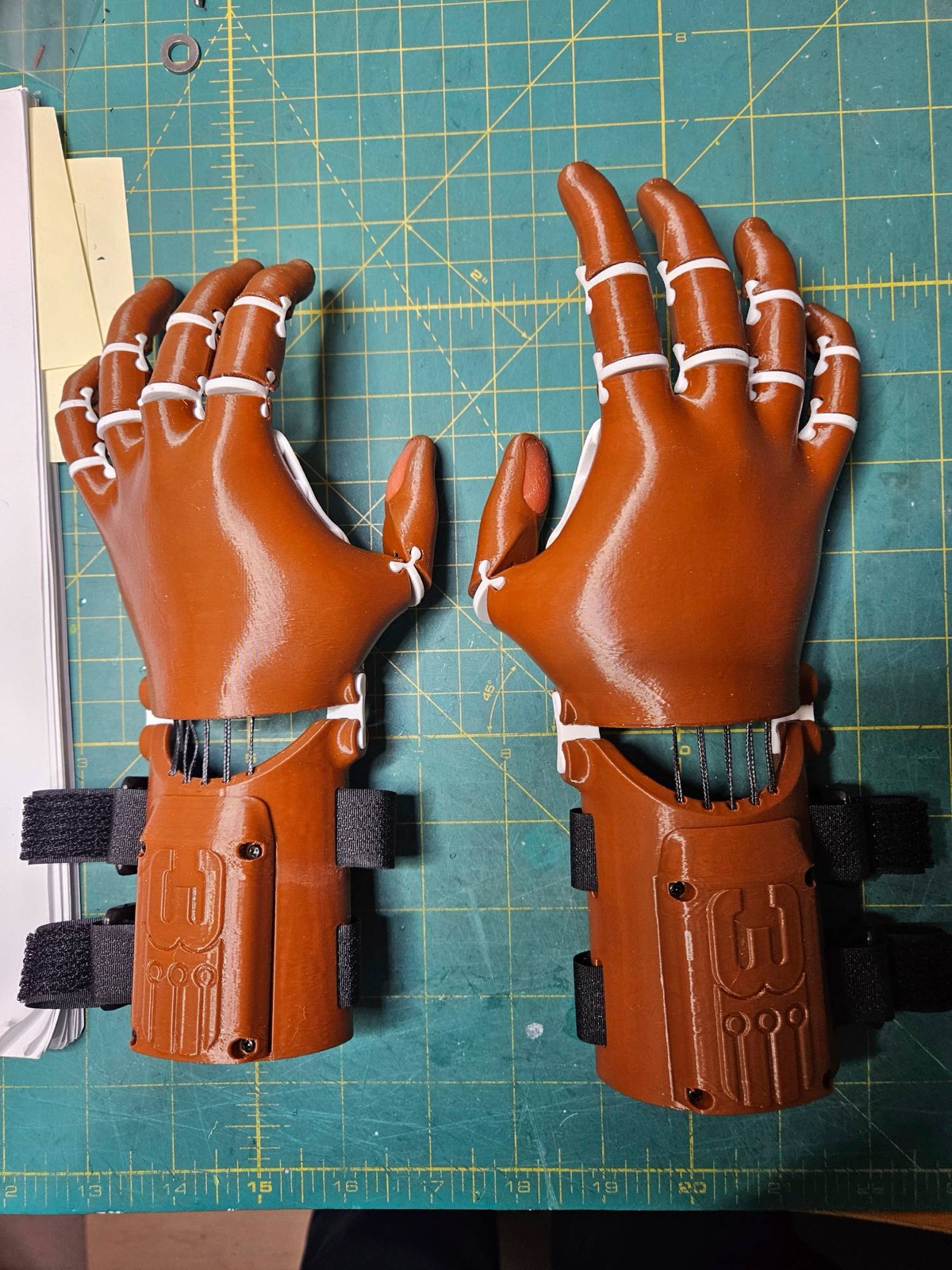 A matching left and right pair of copper hands with white joints